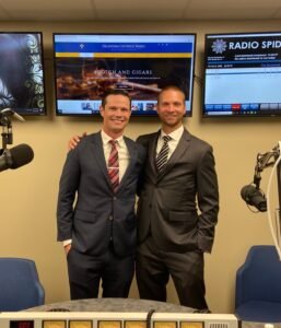 Adam and David inside a recording or radio studio.